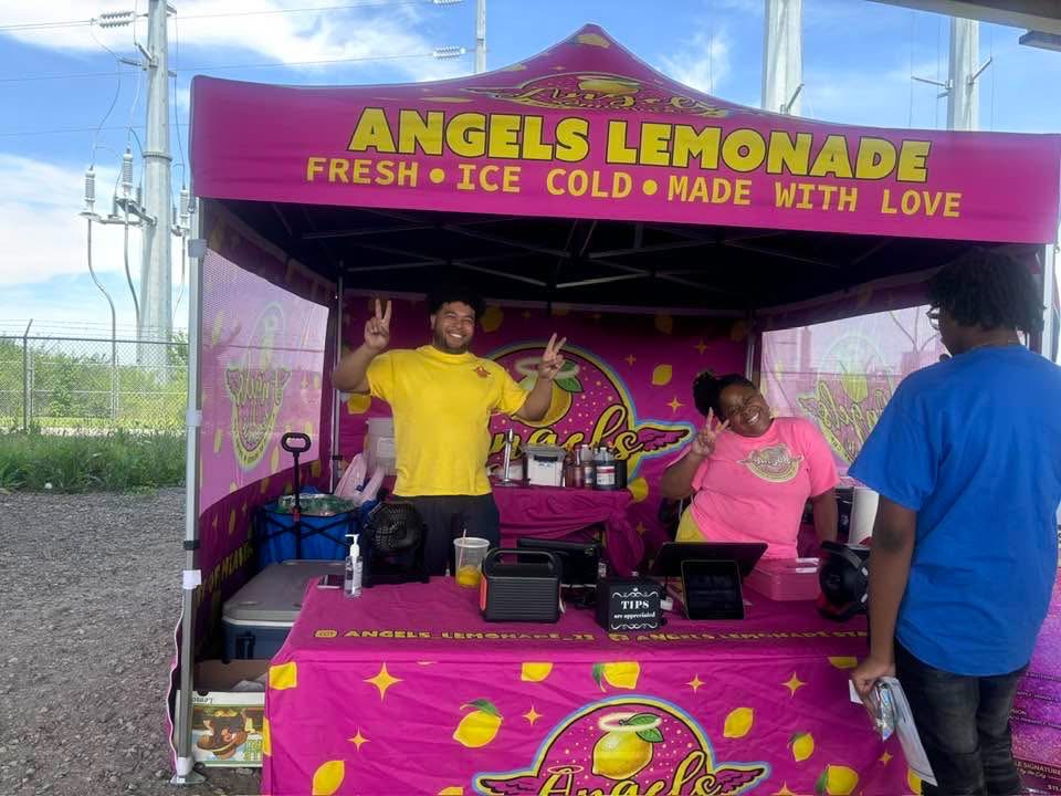 The bright pink Angels Lemonade tent and booth serving fresh handcrafted lemonade at local Louisville events and festivals